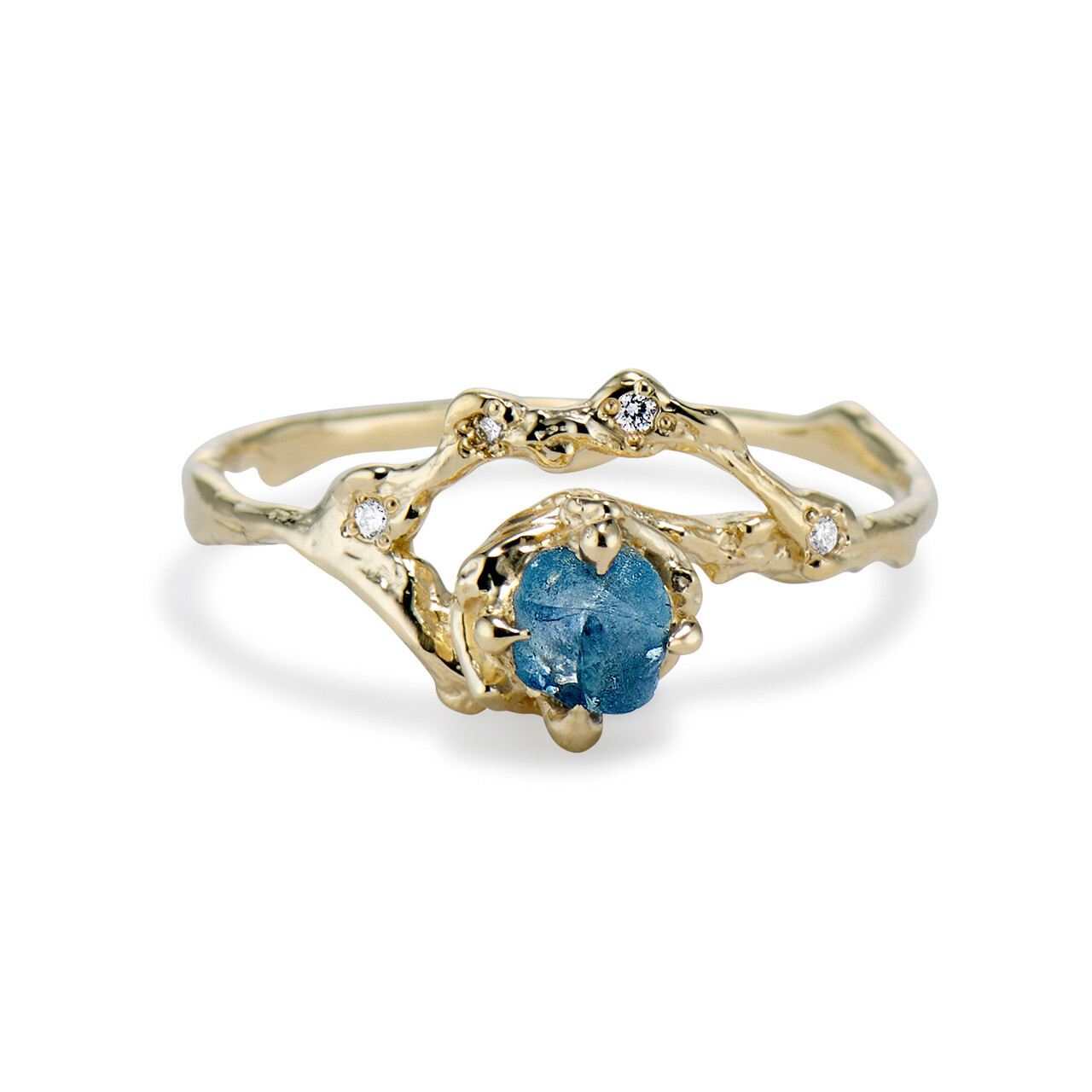 rough blue montana sapphire in a half halo yellow gold setting