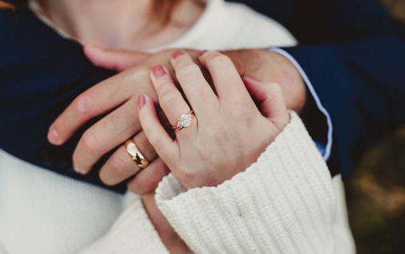 couple embracing with a diamond ring