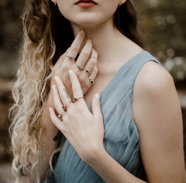woman in a blue dress editorial woman in a blue dress with multiple olivia ewing jewelry engagement rings