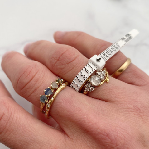 Olivia Ewing Montana sapphire engagement ring and a complimentary ring sizer