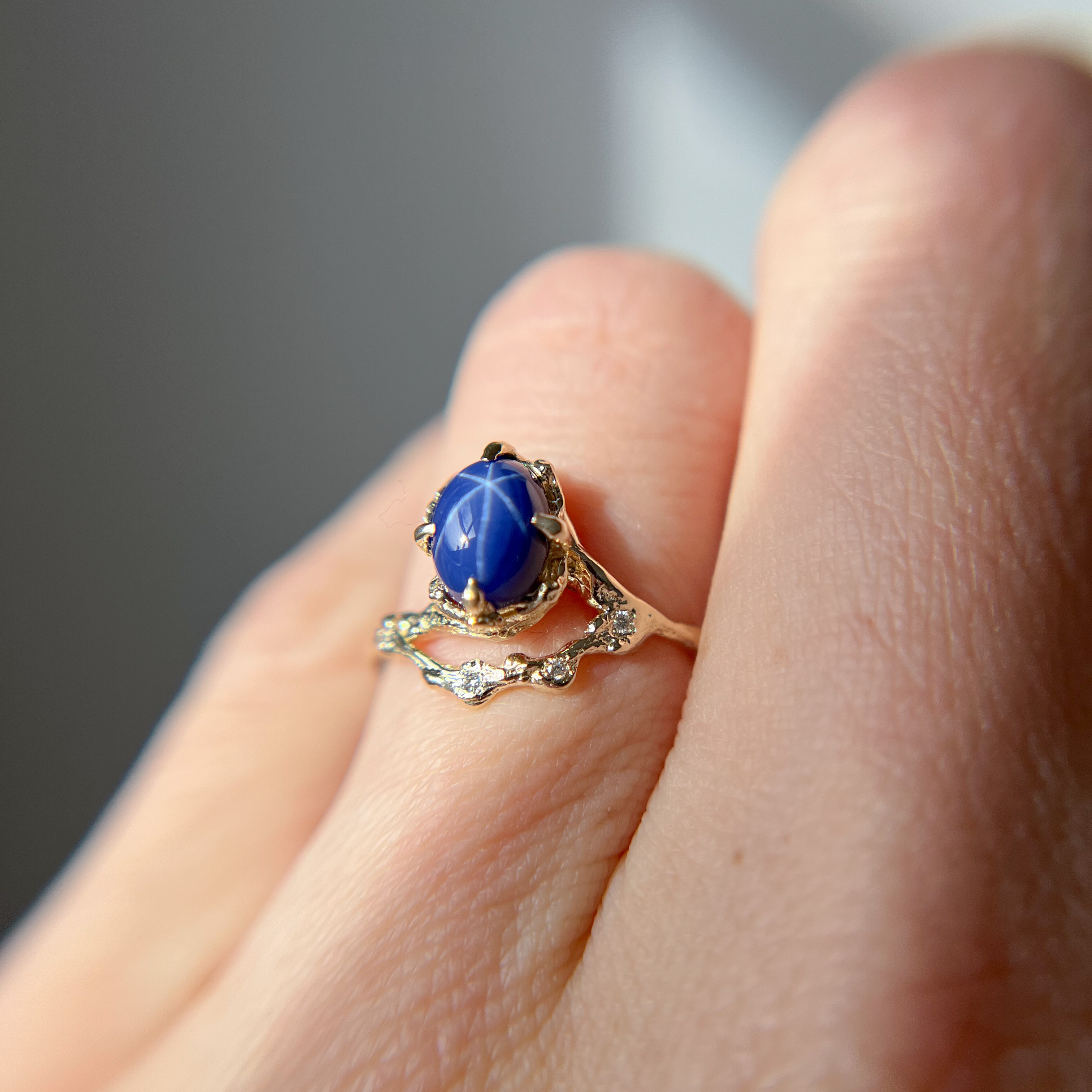 star sapphire half halo ring in yellow gold 